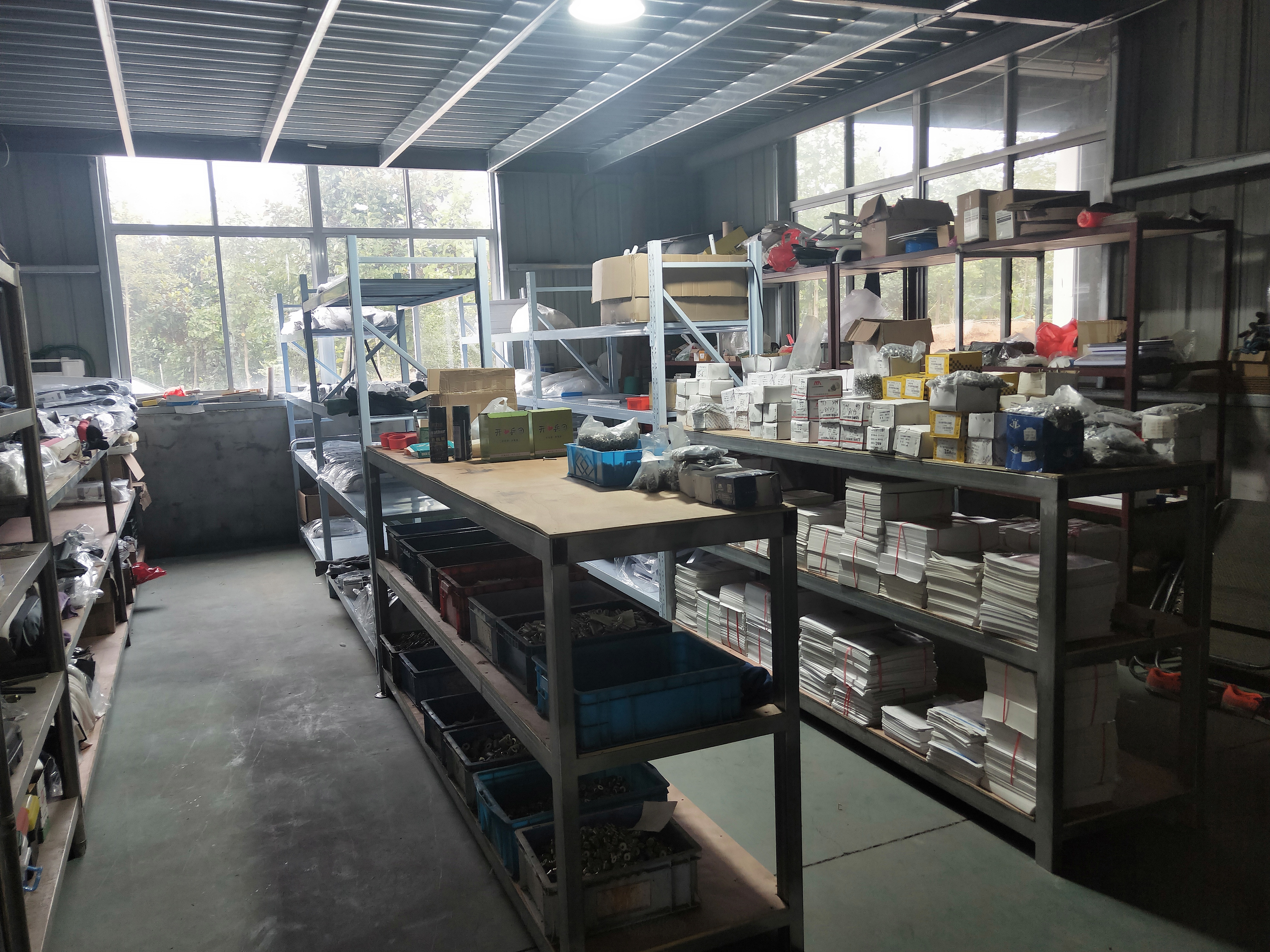 Donghe component work area with organized parts and work surfaces