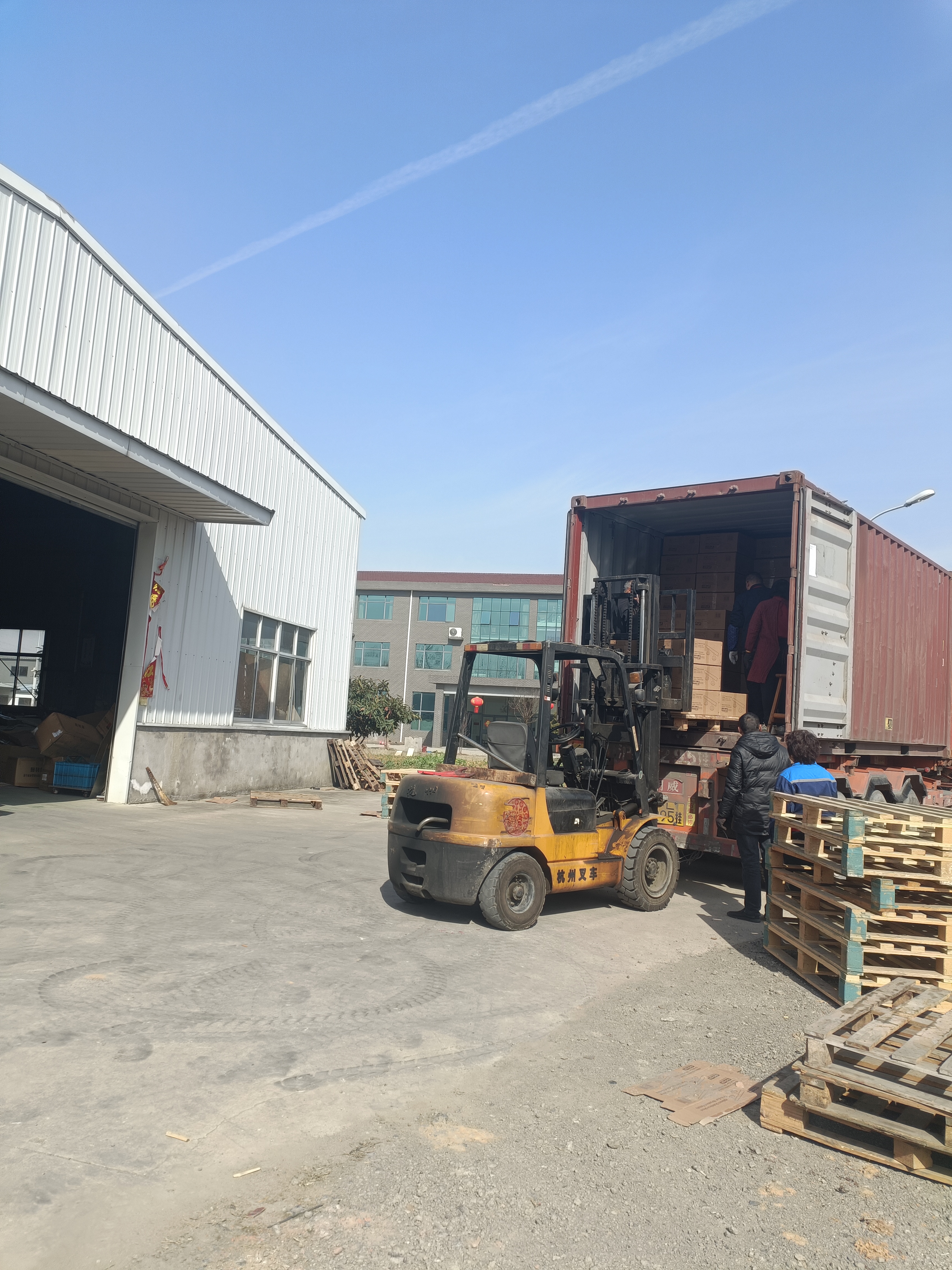 Forklift moving materials beside the Donghe facility loading area
