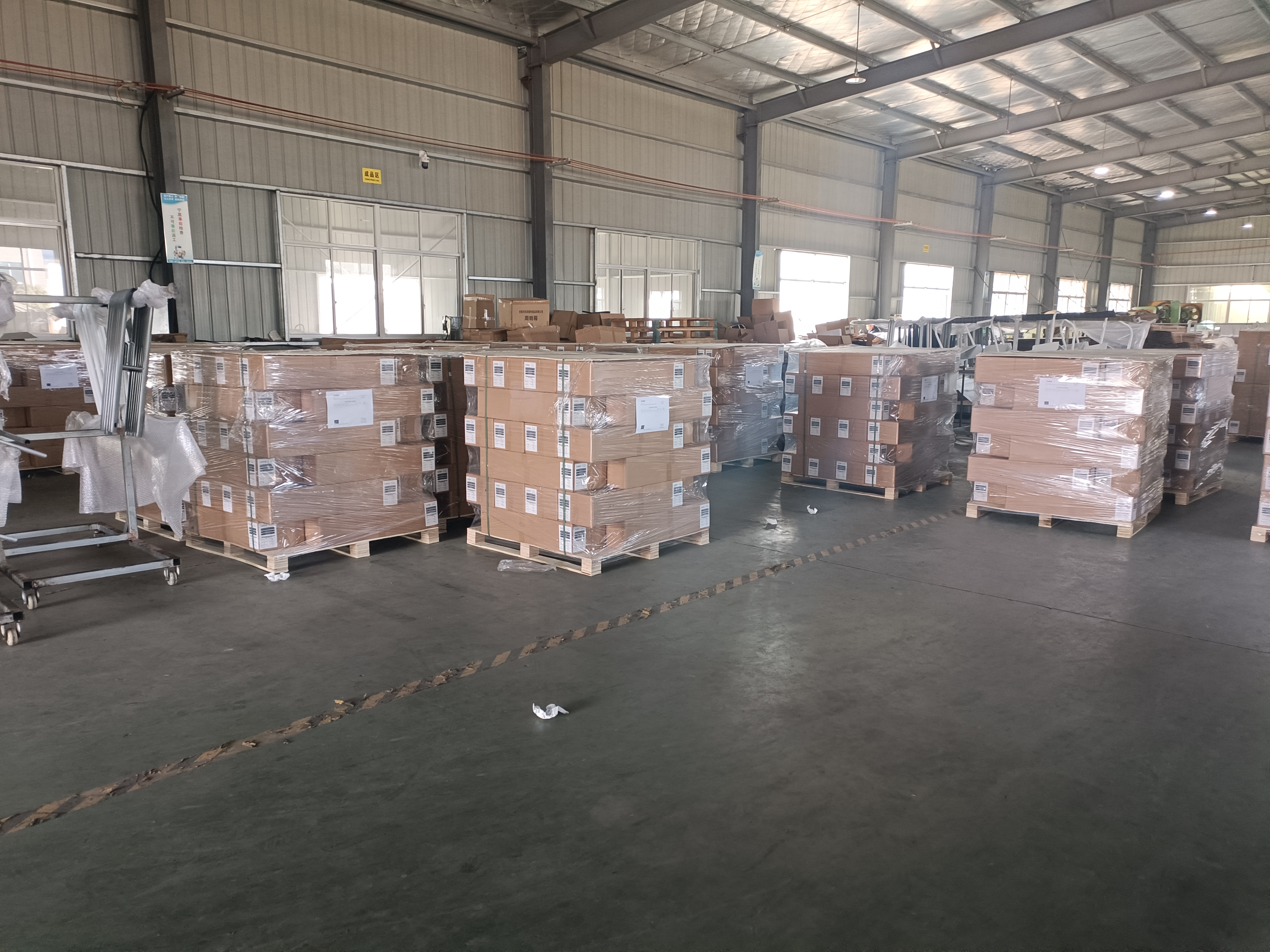 Finished cartons and pallets staged for shipment inside the workshop